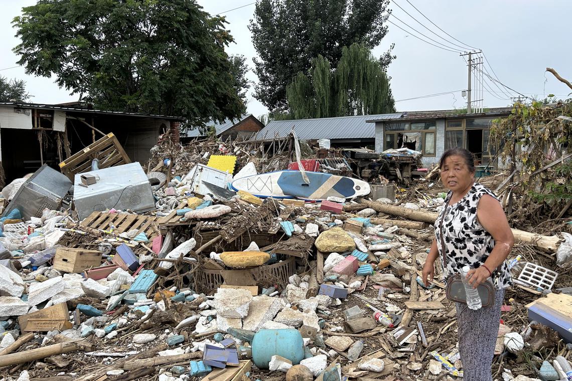 李大娘回到灾后废墟拾捡废品,希望能换些钱贴补生活 李大娘回到灾后废墟拾捡废品,希望能换些钱贴补生活